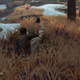 A stealth lesson early in the game. Hide in the tall grass, and you can take out an enemy without making a ruckus, though the yellow outline on the other guard indicates rising suspicion.